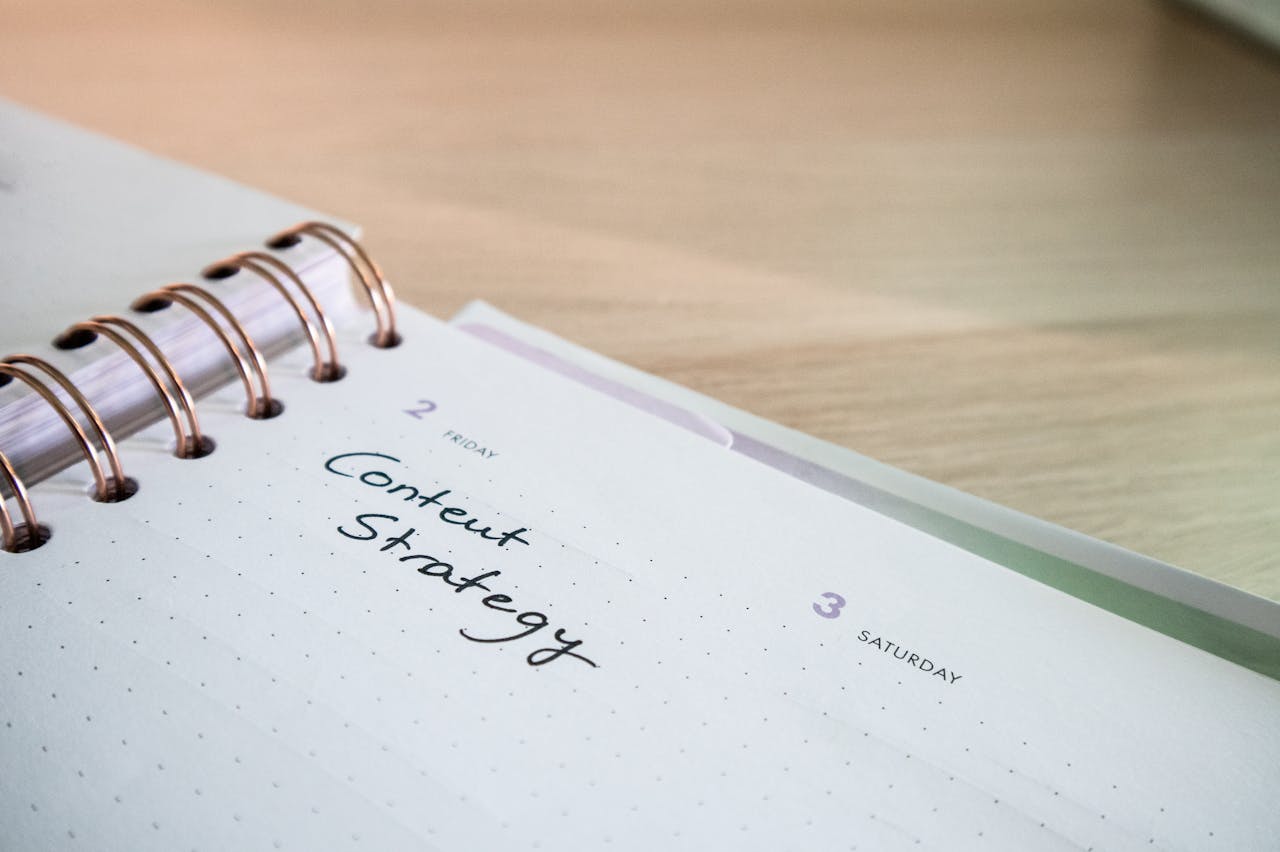 Close-up of a notebook page with Content Strategy written on it, ideal for business planning visuals.